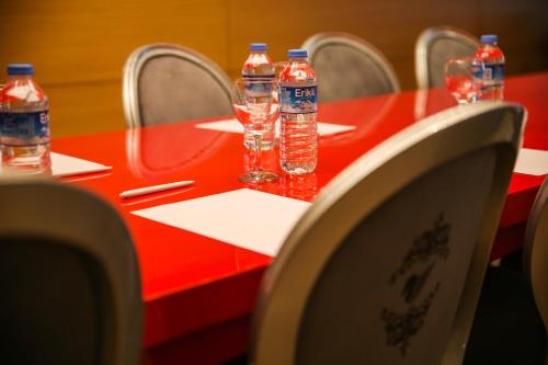 a red table with bottles of water on it at New Gate Hotel in Ankara