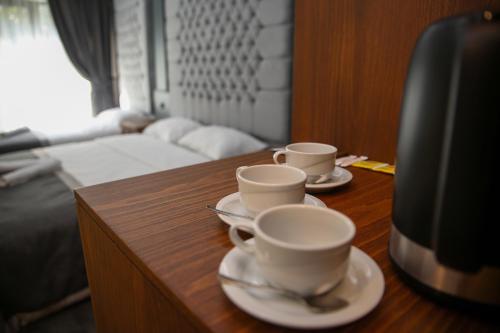 two coffee cups and saucers on a wooden table at New Gate Hotel in Ankara