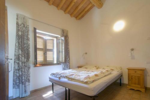 a bedroom with a bed and a window in it at Tenuta Tredici Ulivi in Senigallia
