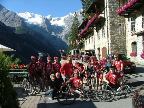 a group of people posing for a picture with their bikes at Hotel Madatsch in Trafoi