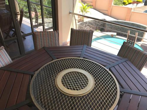 a wooden table with a bowl on top of it at Jay and Bee Guesthouse in Durban