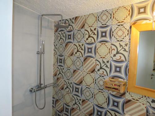 a bathroom with a shower curtain and a mirror at Blue Beach Villas Apartments in Stavros