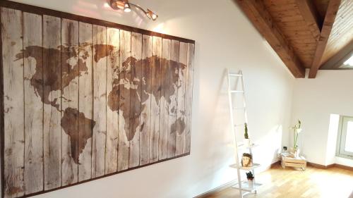 a wooden world map on a wall in a room at Donizetti Royal in Bergamo