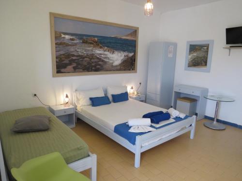 a bedroom with a bed and a chair in it at Blue Beach Villas Apartments in Stavros