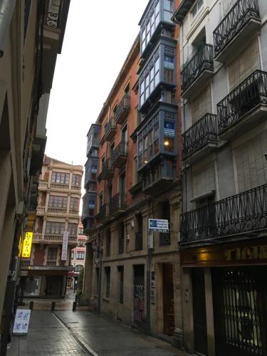 an empty street in a city with tall buildings at Pensión La Bilbaina - Albergue Logroño in Logroño