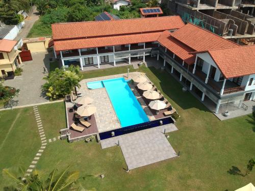 an aerial view of a house with a swimming pool at IMAGINE Villa Hotel in Mirissa