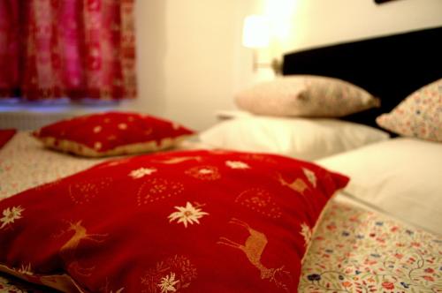 a bed with red pillows on top of it at Haus Susanne in Radstadt