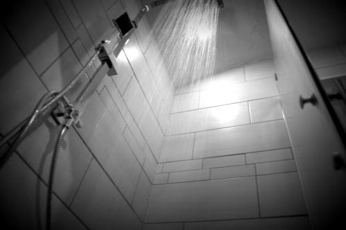a bathroom with a shower with a shower head and water at Haus Susanne in Radstadt