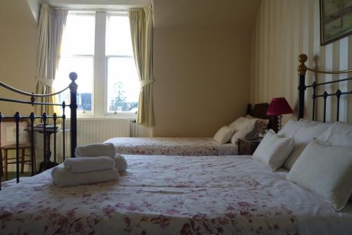 Ένα ή περισσότερα κρεβάτια σε δωμάτιο στο Dunallan Guest House