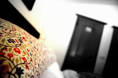 a pillow with a floral pattern next to a dresser at Haus Susanne in Radstadt