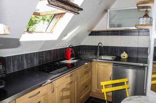 a kitchen with a sink and a stove at Le studio d'Evelyne in Dieppe
