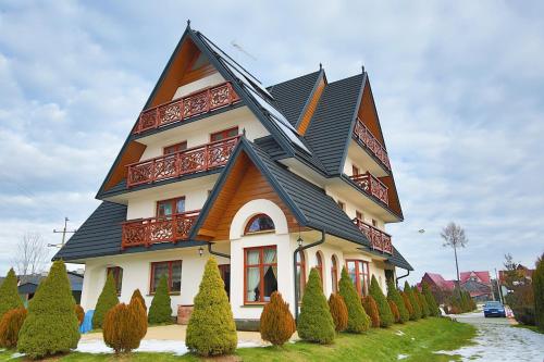 a large house with a gambrel roof at Sarenka in Białka Tatrzańska