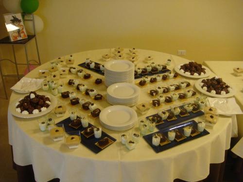 a table with a bunch of desserts on it at Santa Loja Hotel Residence in Tito