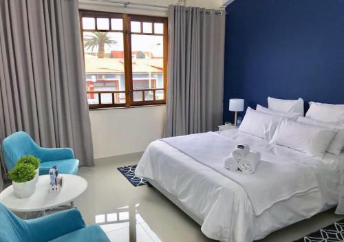 a bedroom with a large bed with a blue wall at Bismarck 2 in Swakopmund