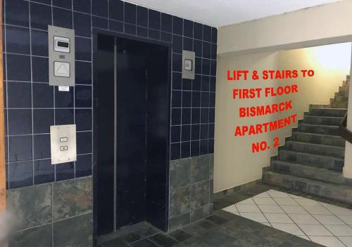 a bathroom with a sign that says first floor bathroom bathroomartificial istg at Bismarck 2 in Swakopmund