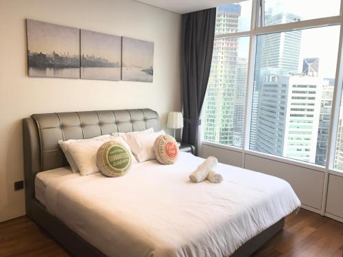 a bedroom with a bed with two stuffed animals on it at VORTEX SUITES KLCC by PNUT With NETFLIX in Kuala Lumpur