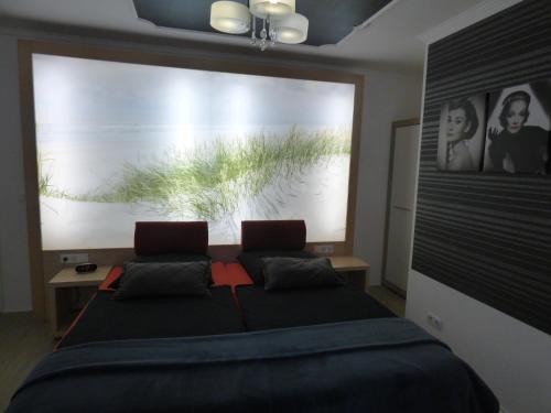 a bedroom with a large window with a bed and two chairs at Landhaus "Am Sonnenberg" in Diekholzen