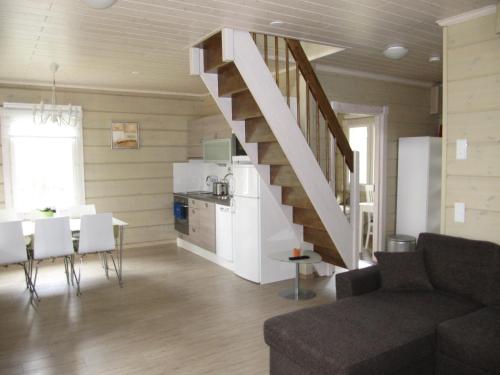 a living room and kitchen with a staircase in a house at Pyhäjärven Lomakylä in Ruolahti