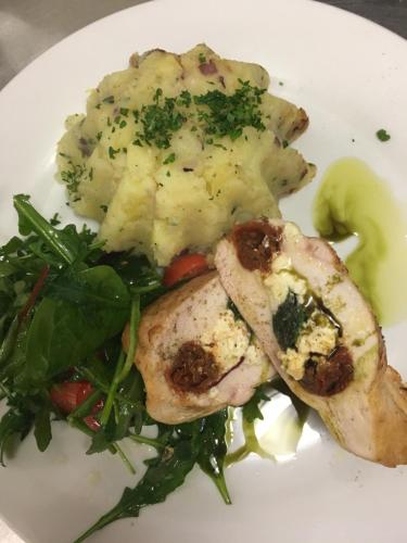 a plate of food with meat and a salad at Penzion Na Solné stezce in Kašperské Hory