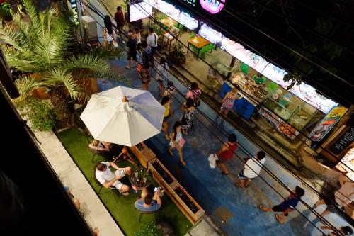 an overhead view of people in a store with an umbrella at Bloom Cafe & Hostel in Ko Lipe
