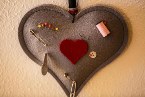 a heart made out of felt with pins and a needle at Am Dorfplatz Suites - Adults friendly in Sankt Anton am Arlberg