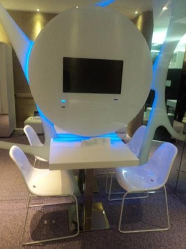 a white table and chairs with a tv on it at A Point Arezzo Park Hotel in Arezzo