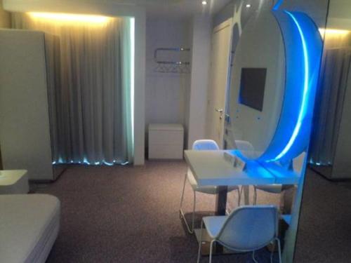 a hospital room with a large mirror and chairs at A Point Arezzo Park Hotel in Arezzo