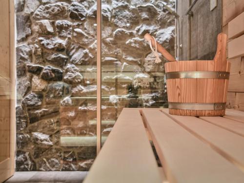 a wooden bucket sitting on a table with a pen at Omesberg-Hütt'n in Lech am Arlberg
