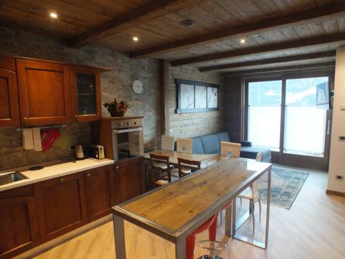 a kitchen with a table and chairs in a room at Best House in Bormio