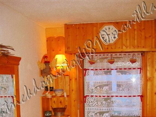 a room with a window with a clock on the wall at TOP 4810 MONT-BLANC in Chamonix-Mont-Blanc