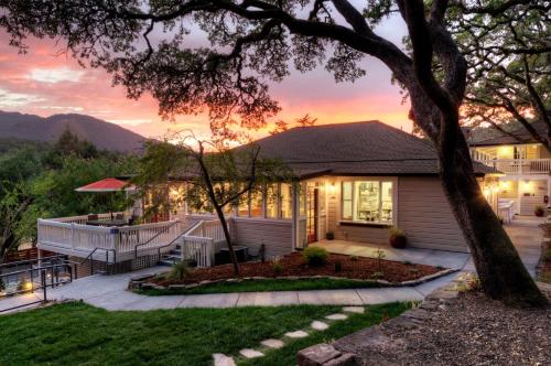 a house with a sunset in the background at Olea Hotel in Glen Ellen