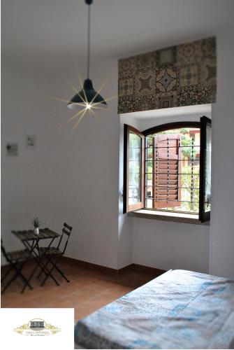 a bedroom with a ceiling fan and a table at Villa Antinea in Avellino