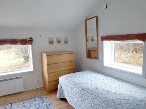 a bedroom with a bed and a dresser and a mirror at Häradssätter Gård in Valdemarsvik