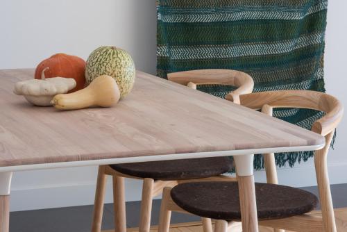 a wooden table with vegetables sitting on top of it at Craveiral Farmhouse by Belong Staying & Feeling in São Teotónio