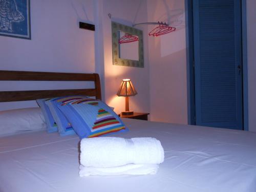 a bedroom with a bed with towels on it at Pousada Baluarte in Salvador