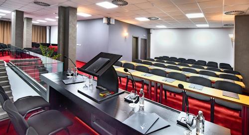 an empty lecture hall with chairs and a podium at Best Boutique Hotel in Stara Zagora