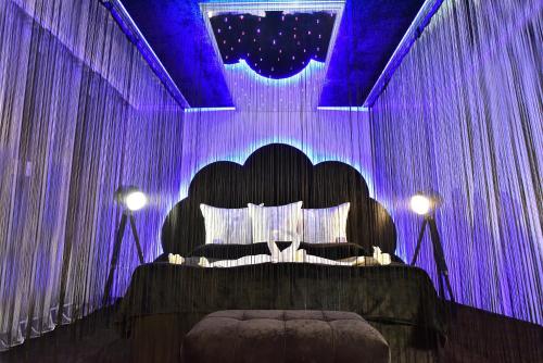 a bedroom with a black bed with purple lighting at Best Boutique Hotel in Stara Zagora