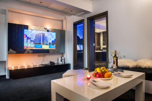 a living room with a table with a bowl of fruit on it at Best Boutique Hotel in Stara Zagora
