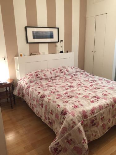 una camera da letto con un letto con copriletto floreale di Polo Residence a Firenze