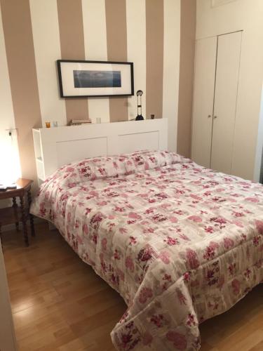 a bedroom with a bed with a floral bedspread at Polo Residence in Florence