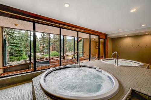a large tub in a room with windows at Lake Louise Inn in Lake Louise