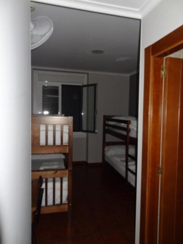 a room with two bunk beds and a mirror at Pensión La Bilbaina - Albergue Logroño in Logroño