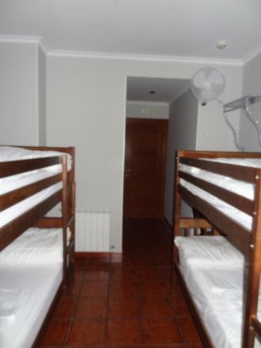 two bunk beds in a room with a hallway at Pensión La Bilbaina - Albergue Logroño in Logroño