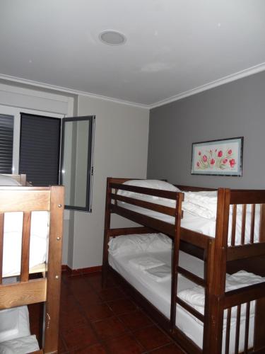 a bedroom with two bunk beds and a mirror at Pensión La Bilbaina - Albergue Logroño in Logroño