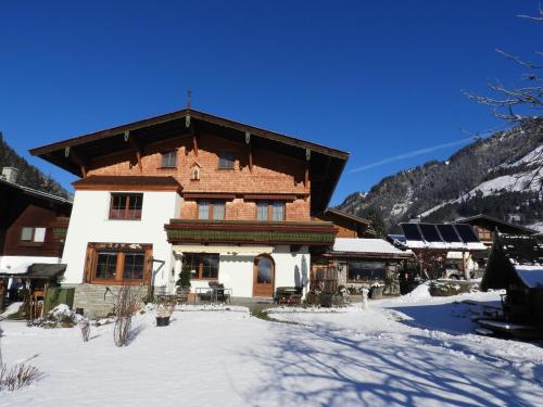 a large building with snow on the ground at Landhaus Rasser in Rauris