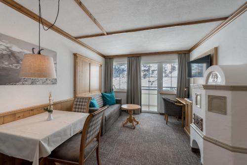 a living room with a table and a couch at Landhaus Jenewein in Obergurgl