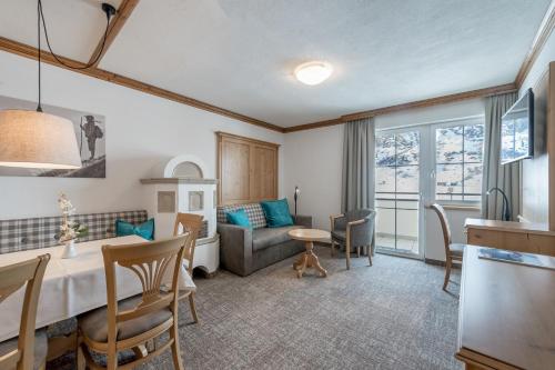a kitchen and living room with a table and a couch at Landhaus Jenewein in Obergurgl