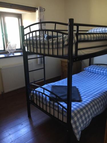 two bunk beds in a room with a window at The Horse Barn in Corsham