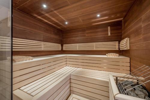a sauna with wooden walls and wooden flooring at Landhaus Jenewein in Obergurgl