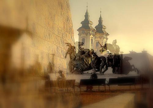 a statue of a man on a horse next to a building at Albina apartman in Eger